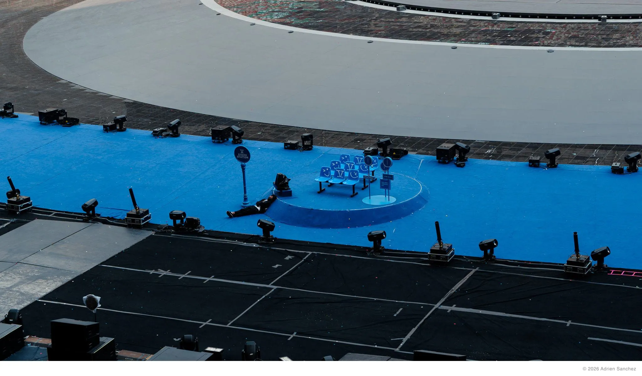 Man sleeping on the stadium floor