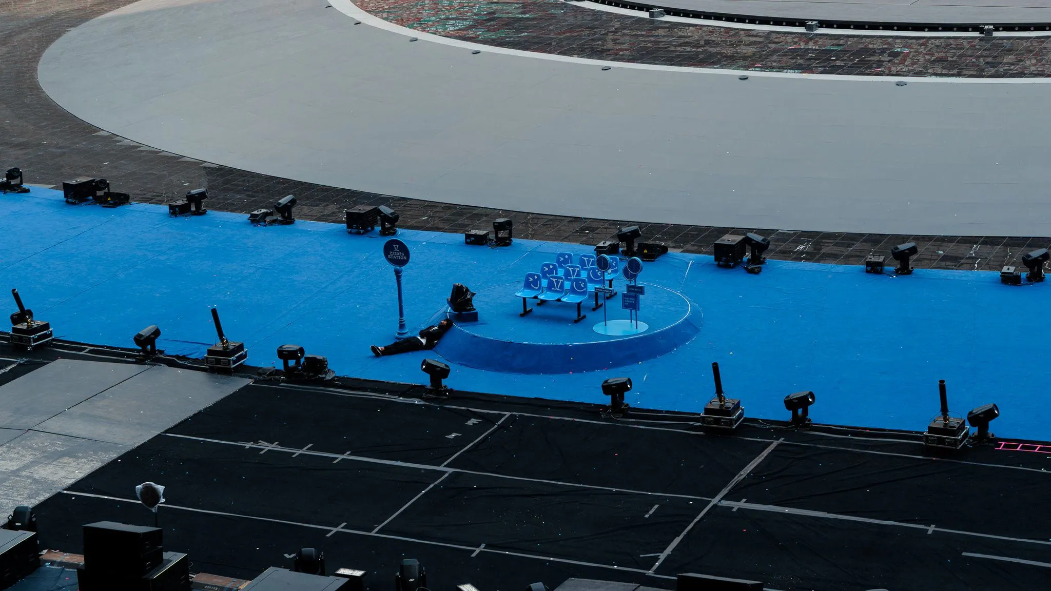 Man sleeping on the stadium floor